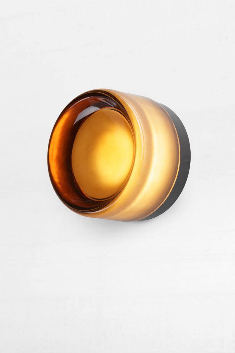 amber eye catching wall light is comprised of a glass exterior over a built-in light source with dome diffuser.&nbsp;