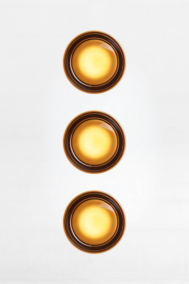 Triple amber Laval Dimple Glass LED Wall Sconce configuration with vertically aligned warm amber glass shades and soft illuminated glow.