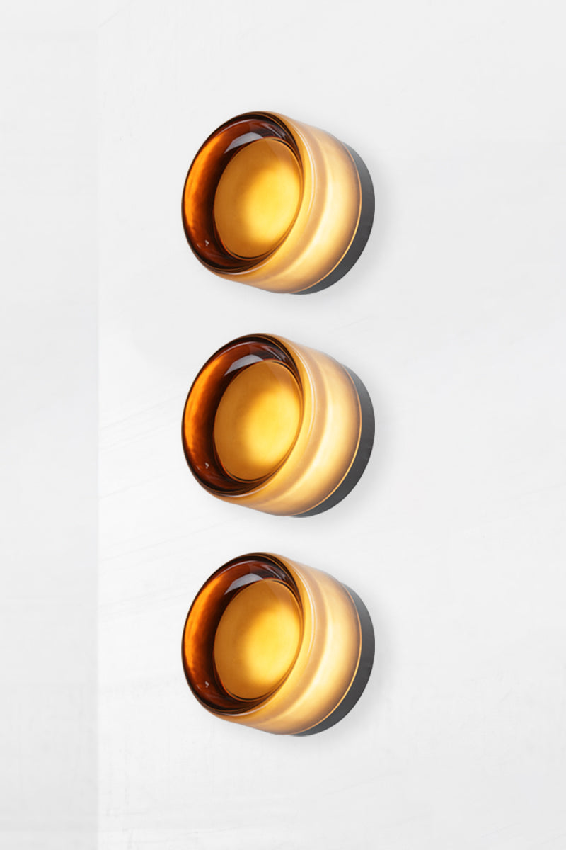 Side profile image of triple amber Laval Dimple Glass LED Wall Sconce bundle showing layered dimple glass detail and black wall mounting plates.