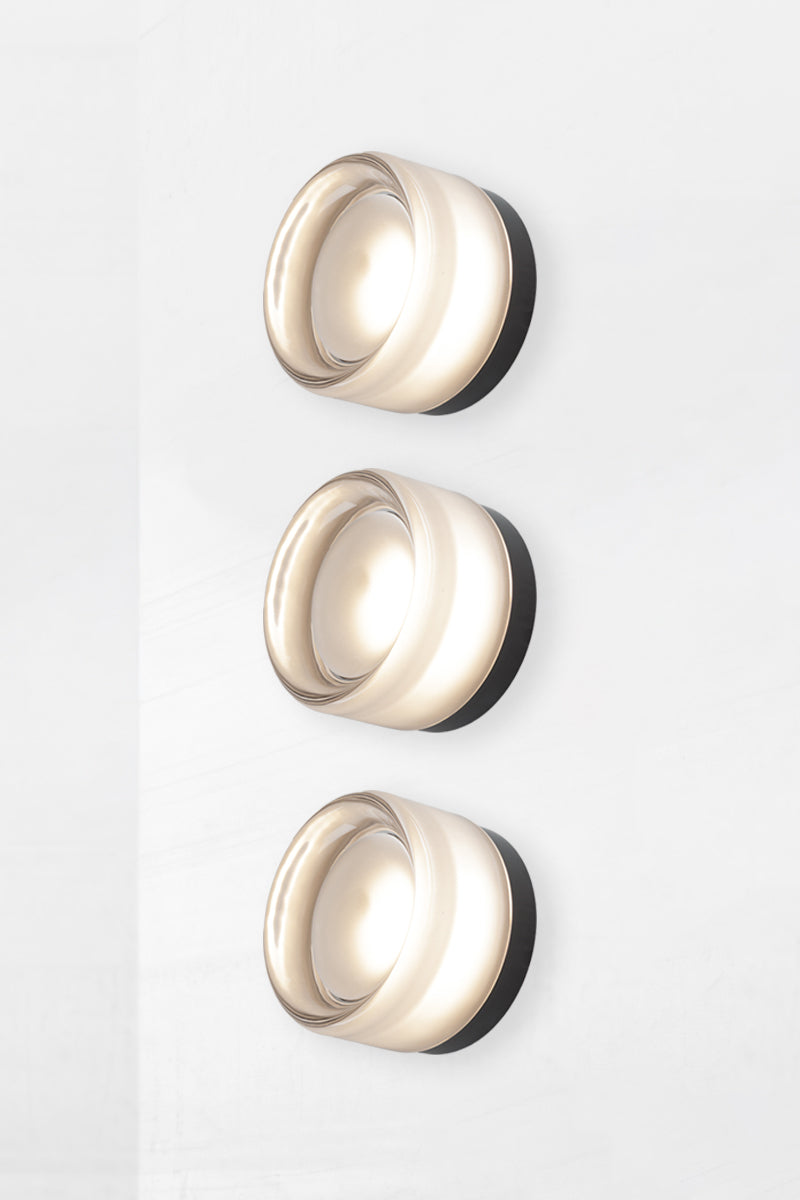 Side angle image of triple frosted Laval Dimple Glass LED Wall Sconce showing textured dimple glass detail and sculptural layered silhouette.