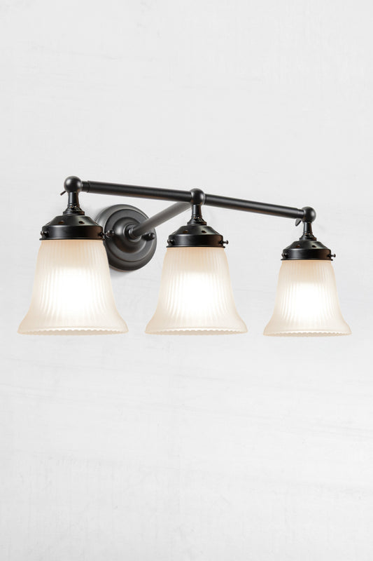 Triple black wall sonce with opal reeded glass shades. 