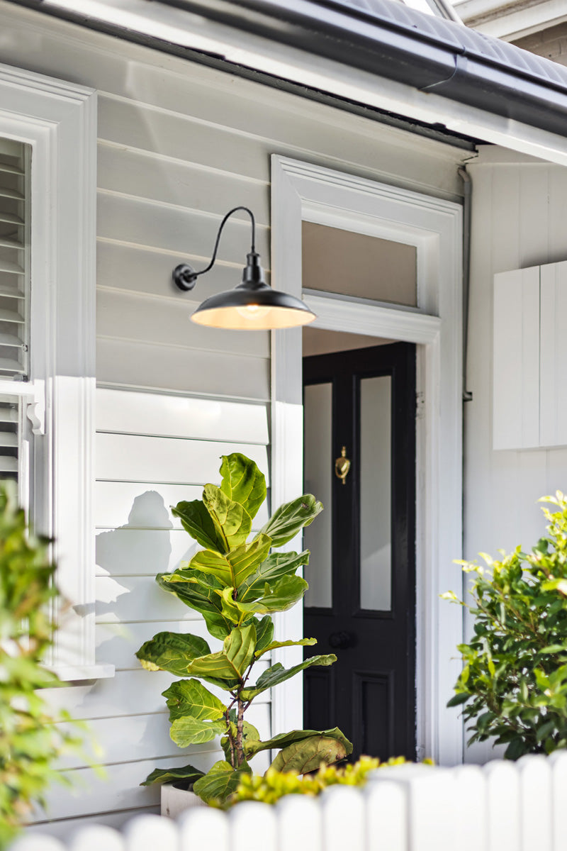 Bullpit shade on an extra large outdoor gooseneck wall sconce, shown as an entrance light of a frontdoor. 