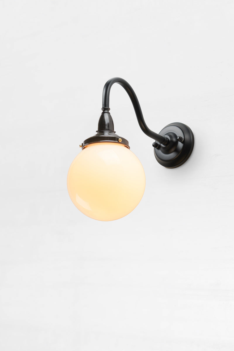 Small black gooseneck outdoor wall light with a bakelite gallery and small opal glass ball shade. 