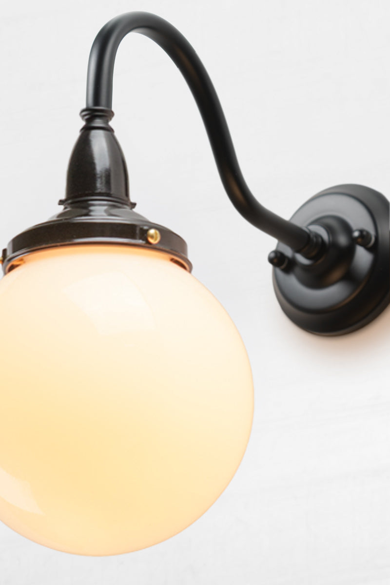 Close up of the glass ball extierior wall sconce with small opal shade. 