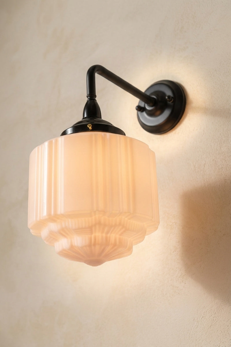 Deco Glass Exterior Wall Light with art deco inspired detailing on its opal glass shade and black 90° wall fixture
