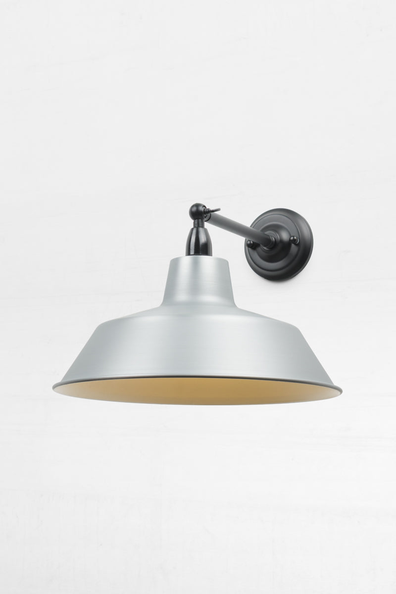 Long straight Arm outdoor wall sconce with a swivel lampholder and a Vintage steel shade.