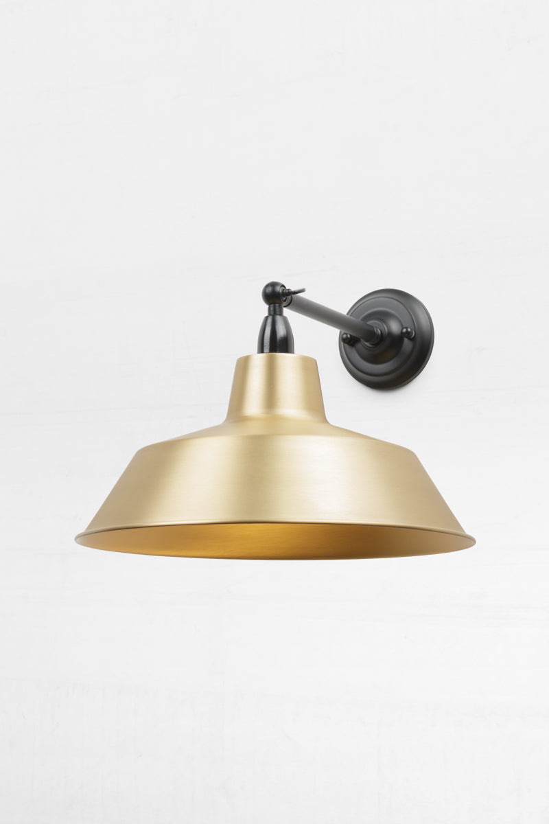 Long straight Arm outdoor wall sconce with a swivel lampholder and a Bright Solid Brass shade. 