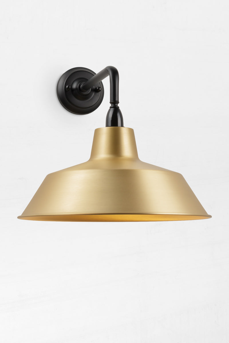 90 Degree outdoor wall sconce with a bright brass shade. 