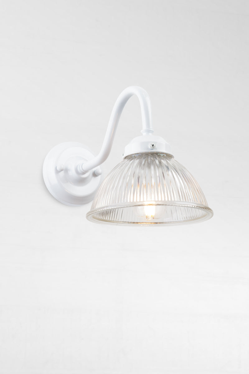 White outdoor gooseneck wall light with a clear ribbed shade. 