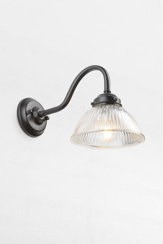 Black outdoor gooseneck wall light with a clear ribbed shade. 