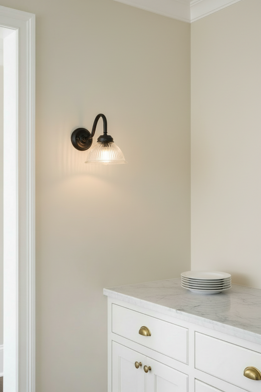 Level view of the black outdoor gooseneck wall light with a clear ribbed shade in pantry