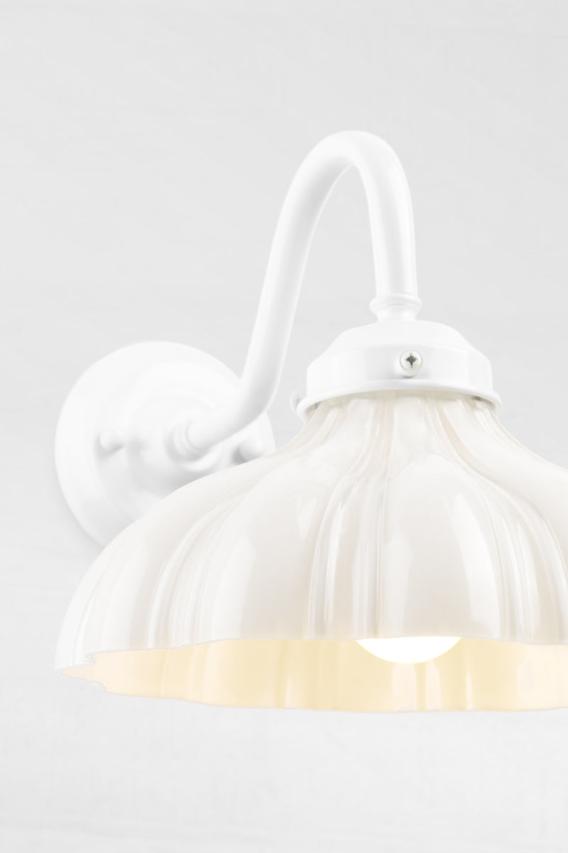 Close up of the white gooseneck wall sconce ond open opal glass shade. 