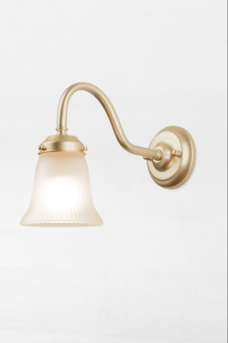 Golde/brass gooseneck wall sconce with integrated gallery and a small opal ribbed glass  shade. 