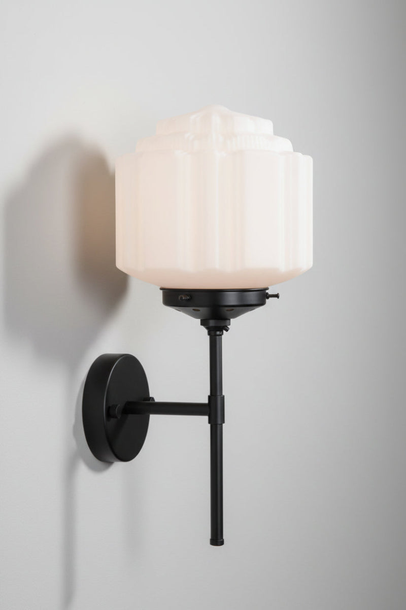 Side view of the Deco opal glass shade paired with a black wall stem sconce. 