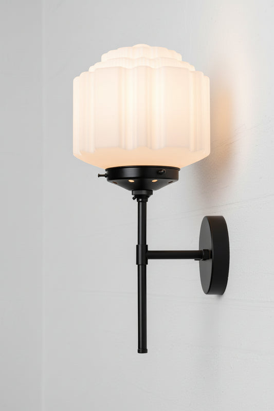 Side view of the black steel stem wall sconce and an opal glass deco shade