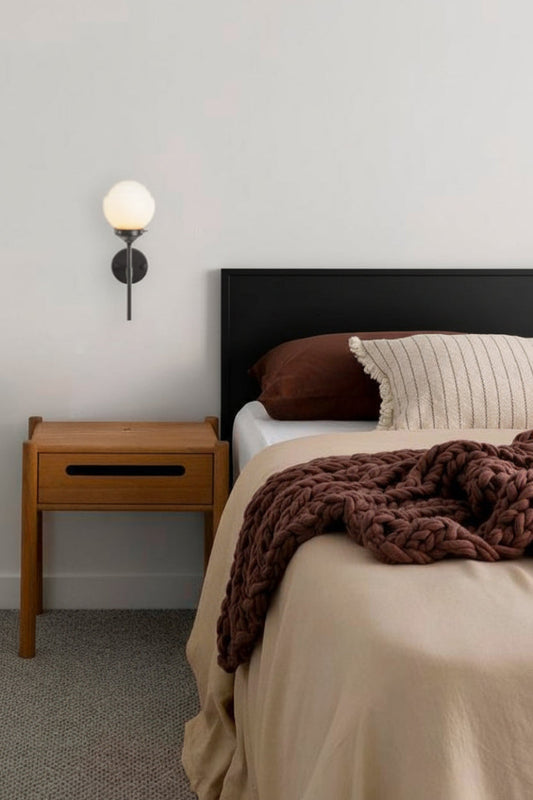 Miami glass schoolhouse shade on a black stem wall sconce as a medside light