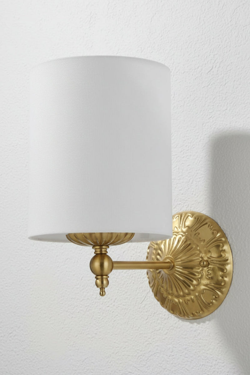 Antique gold finished wall sconce with heritage detailing and a ivory satin shade.  
