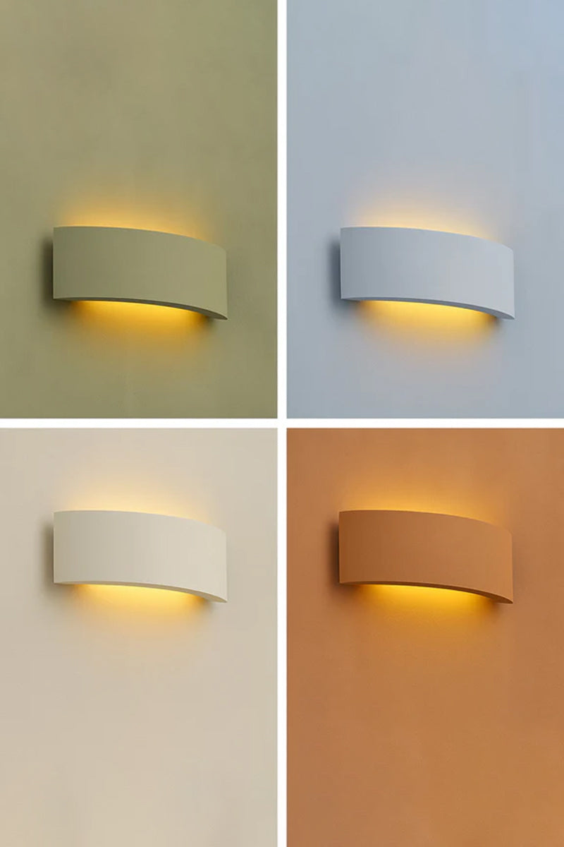 Plaster wall light shown in four painted finish examples including olive green, pale blue, warm beige and mustard tones, demonstrating the ability to customise the plaster surface to suit any interior colour palette.