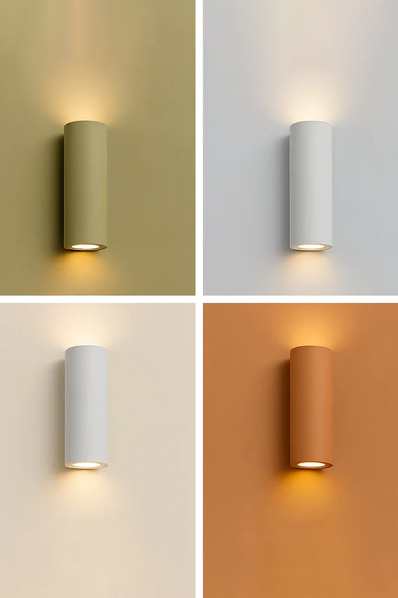 Maines Up Down Plaster Wall Sconce providing soft up and down lighting in modern interior settings with paintable white plaster finish.