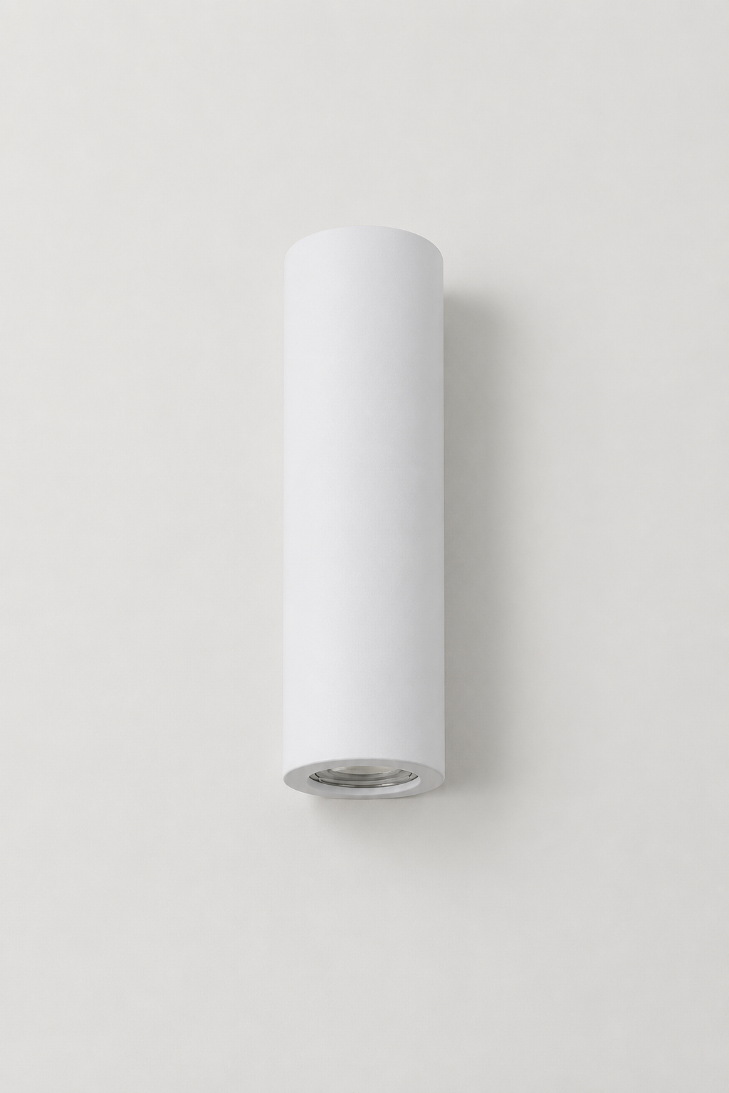 Maines Up Down Plaster Wall Sconce is a minimalist, cylindrical design shown here with lights off.