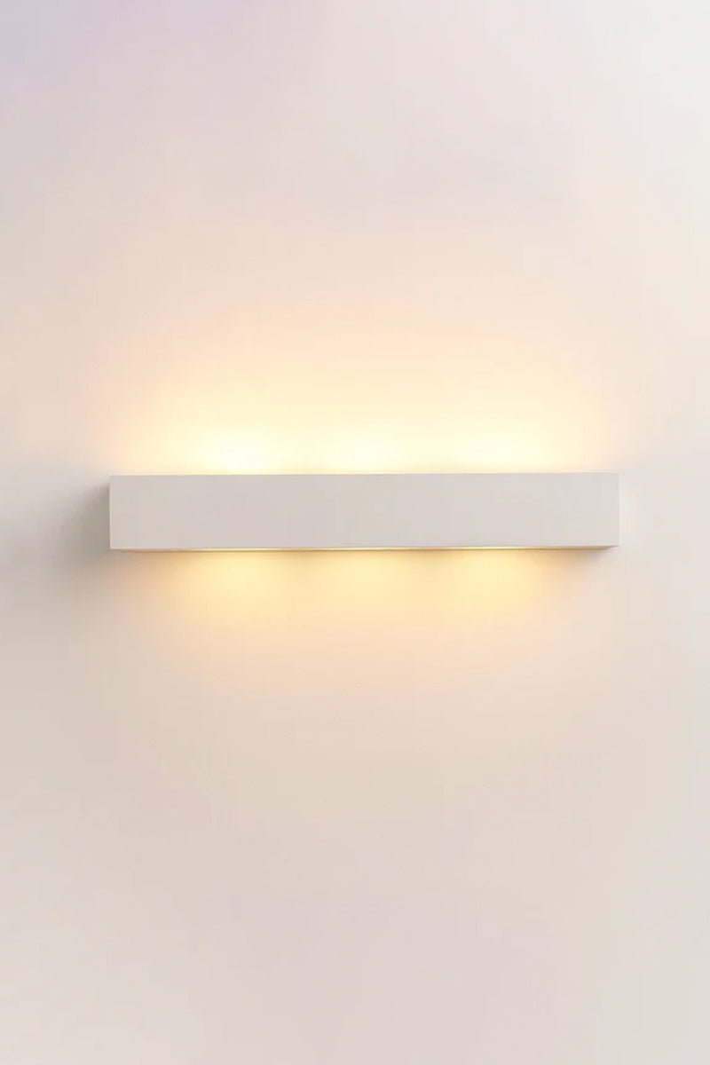Collaroy Plaster Wall Sconce large size illuminated with soft architectural up and down lighting.