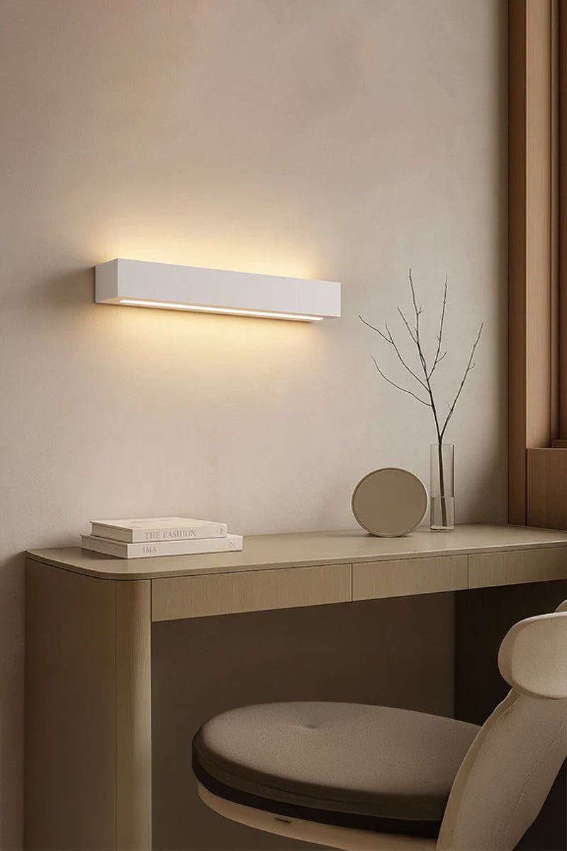 Collaroy Plaster Wall Sconce installed above bedside table creating warm ambient wall lighting.