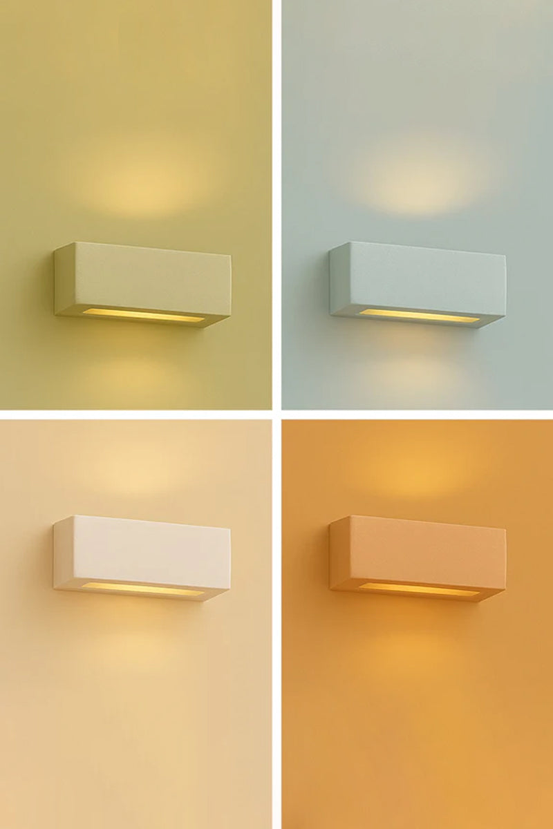 Collaroy Plaster Wall Sconce in a small size shown illuminated with paintable white plaster finish.
