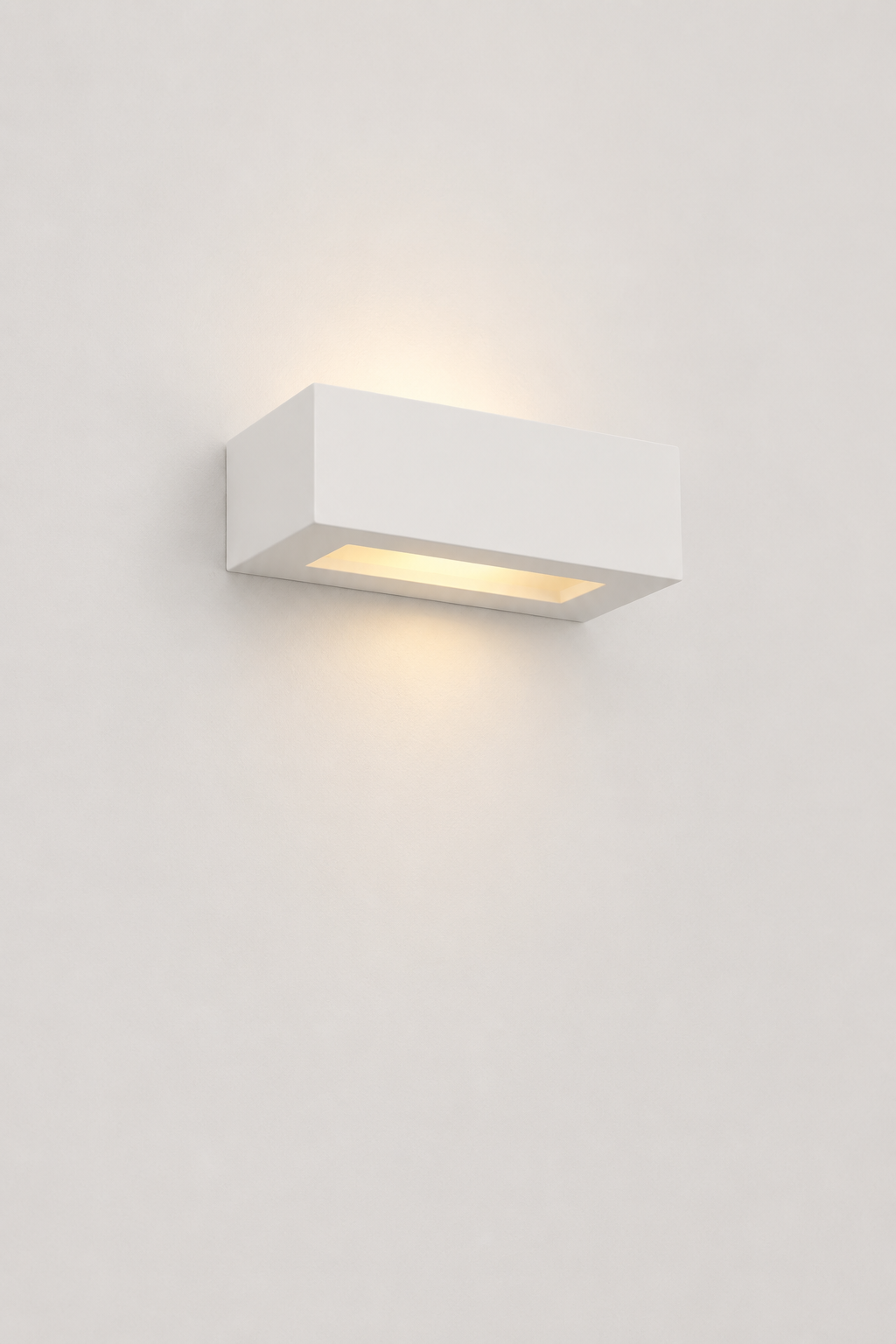 Small rectangular, illuminated, up/ down plaster wall light in white. 