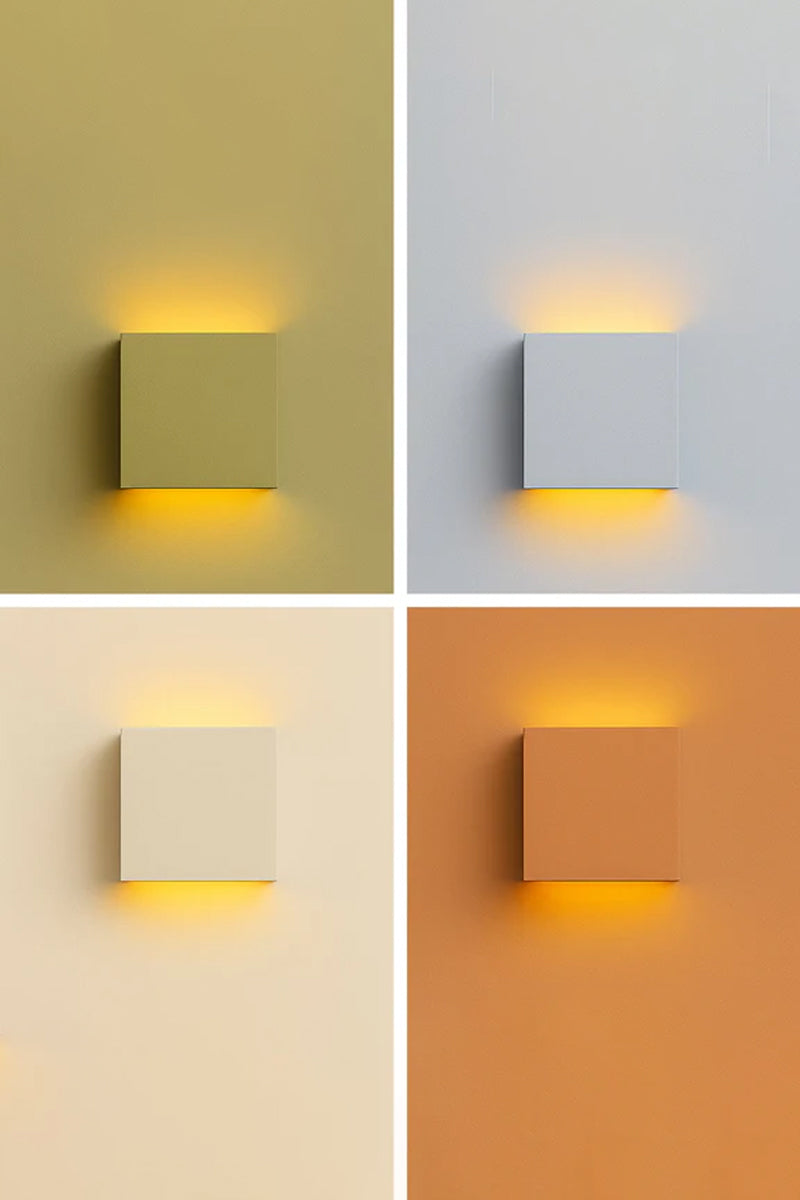 Griffs Plaster Wall Sconce shown illuminated and unlit in four lifestyle colour settings, featuring a paintable white gypsum square wall light with up and down illumination.