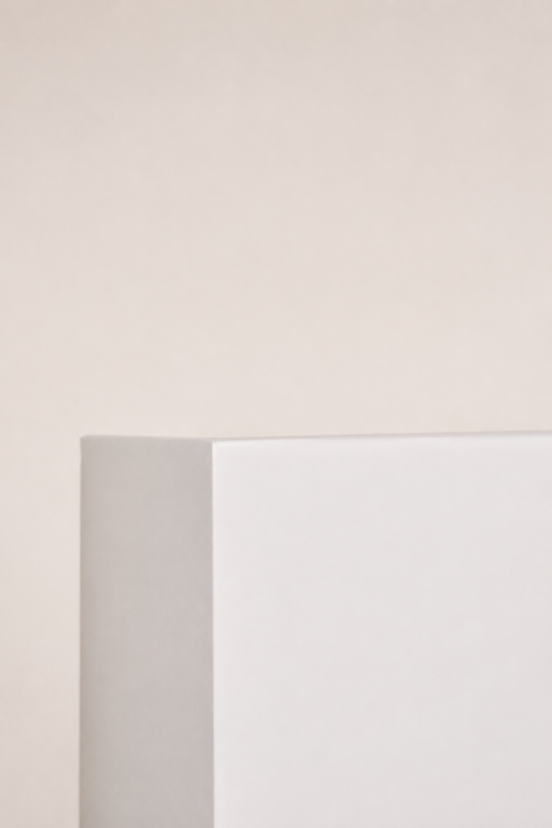 Side profile of the Griffs Plaster Wall Sconce displaying the slim projection and paintable white gypsum construction.