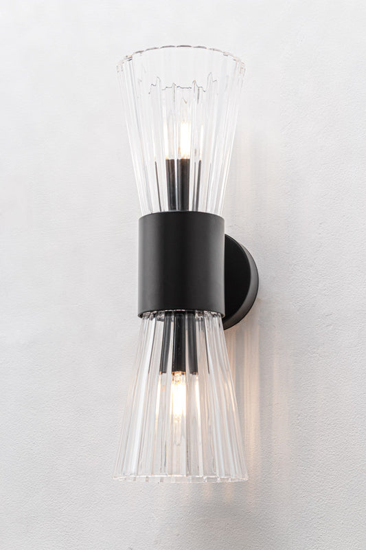Hourglass silhouette with two open-ended fluted glass cones facing up and down with black fitting finish