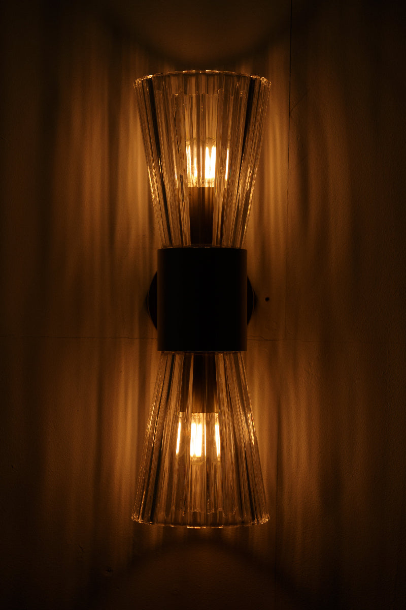 Ribbed clear glass refracts and disperses light for a decorative effect casting a sparkling, prismatic glow across the wall 