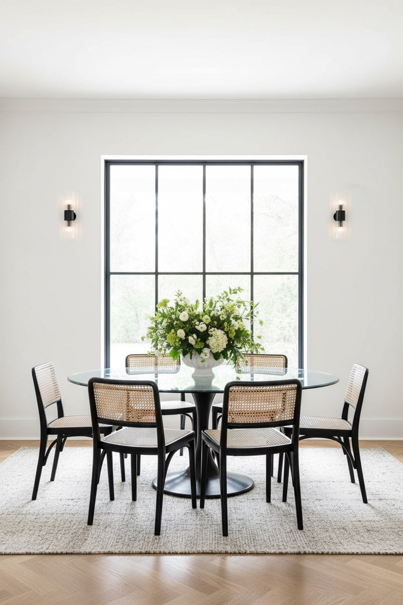 Two Mowbray Double Glass Wall Lights with black steel finish, either side of a modern black framed window in a bright, clean dining space. 