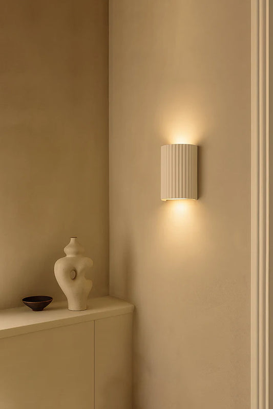 Raynes Plaster Wall Light installed in neutral interior with warm up and down wall lighting