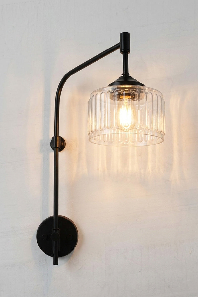 Capri Glass Wing Arm Wall Lamp with clear vertically fluted glass shade and matt black adjustable wall arm