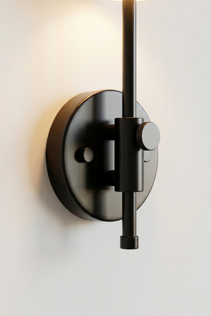 Close-up of matt black wall mount and adjustable arm detail on Capri Glass Wing Arm Wall Lamp