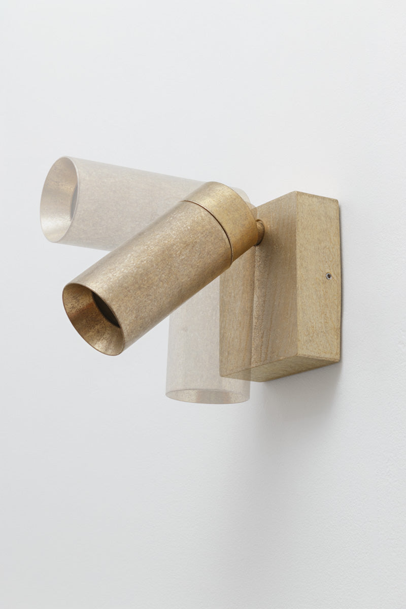 Antique brass adjustable wall light showing the pivoting spotlight head and square wall mounting plate.