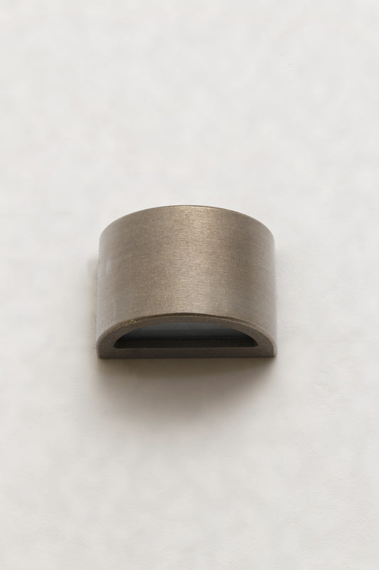 A compact curved step light in Age Brass that casts light downward
