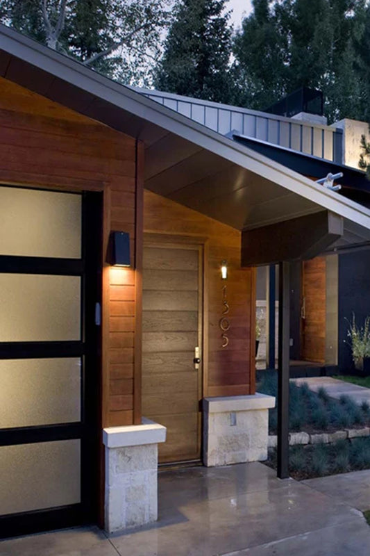 Mills Exterior Wall Light installed beside modern exterior entryway creating subtle architectural lighting
