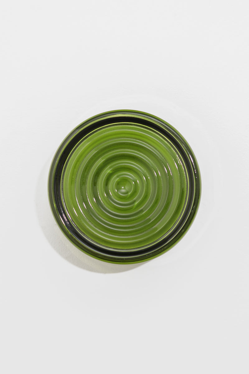 View of the green LED glass wall light with detailed concentric ribbed glass finish.