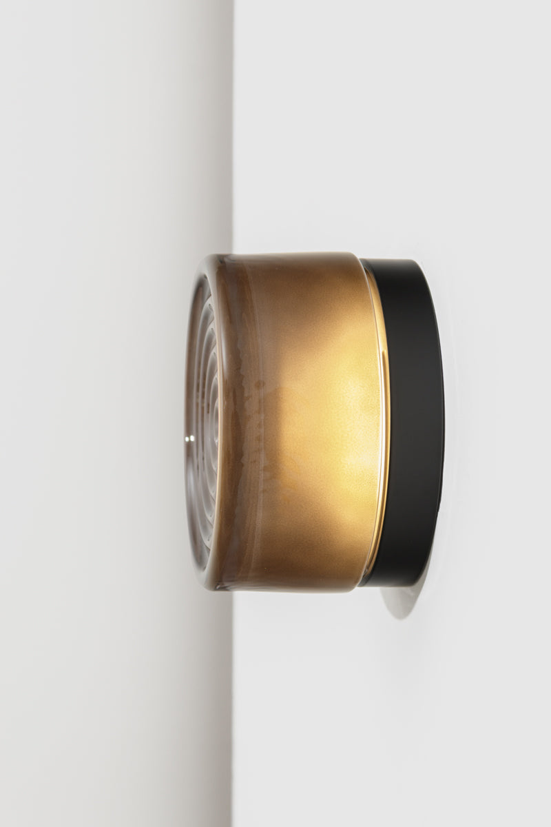 Side profile of the grey LED glass wall light showing smoked glass finish and black mounting base.