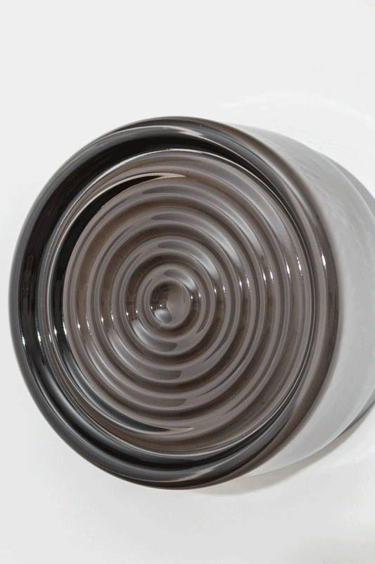 Close-up GIF of the grey LED glass wall light highlighting the smoked ribbed glass texture and circular detailing when on and off. 