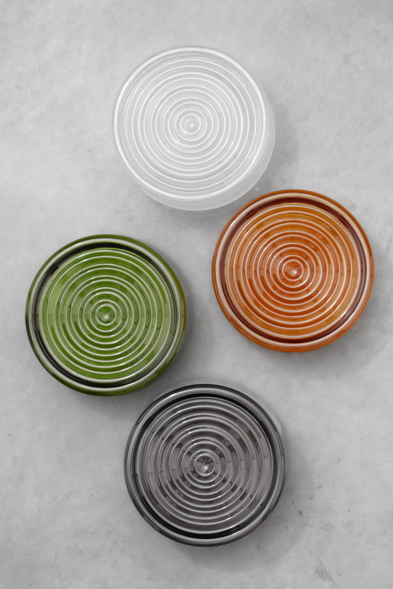 Flat lay of the amber, green and grey LED glass wall lights showing the different glass finish options together.