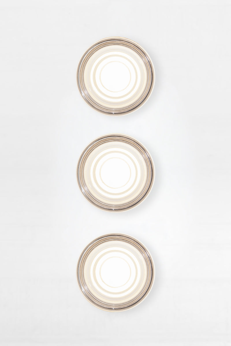 Bundle of three frost LED glass wall lights shown front-on with soft diffused illumination and circular glass texture.
