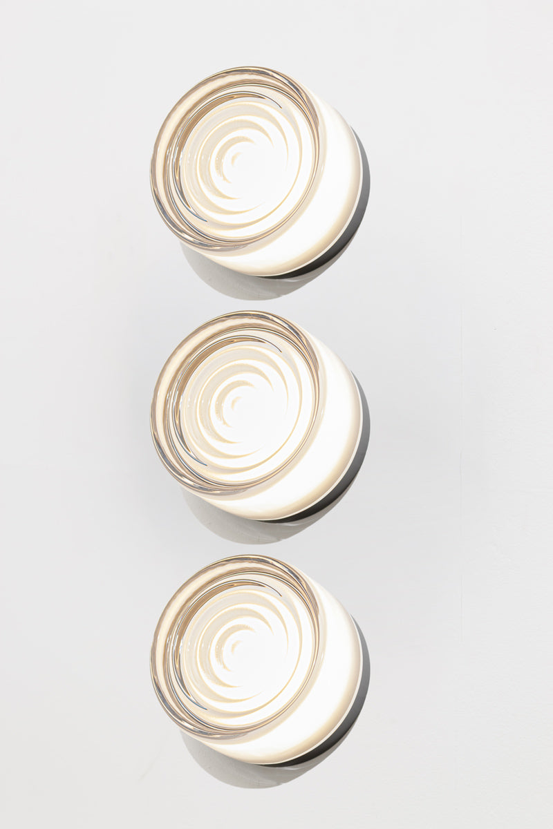 Side profile of three frost LED glass wall lights highlighting the layered frosted glass design and black mounting base.
