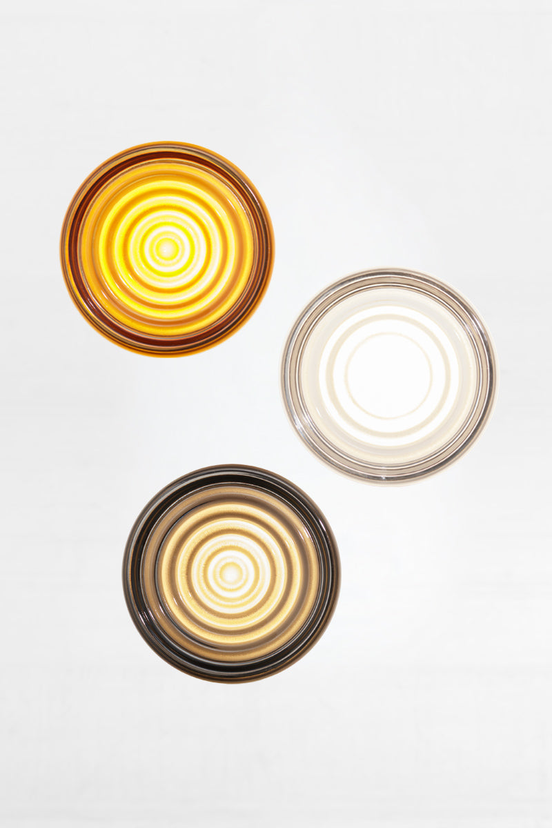 Mixed finish bundle of LED glass wall lights featuring amber, frost and grey glass variations in a clustered arrangement.