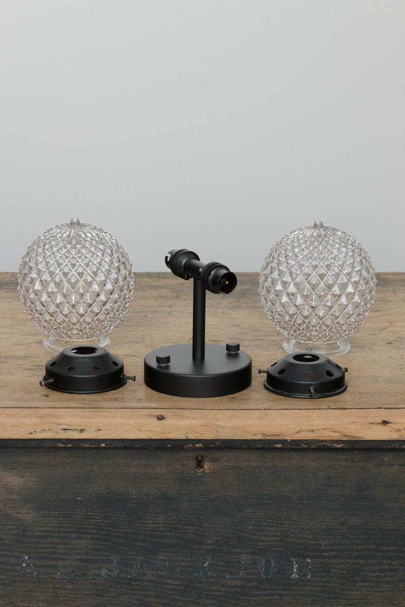 trunk shot of double wall sconce and two clear glass orbs with a vintage-inspired diamond cut design