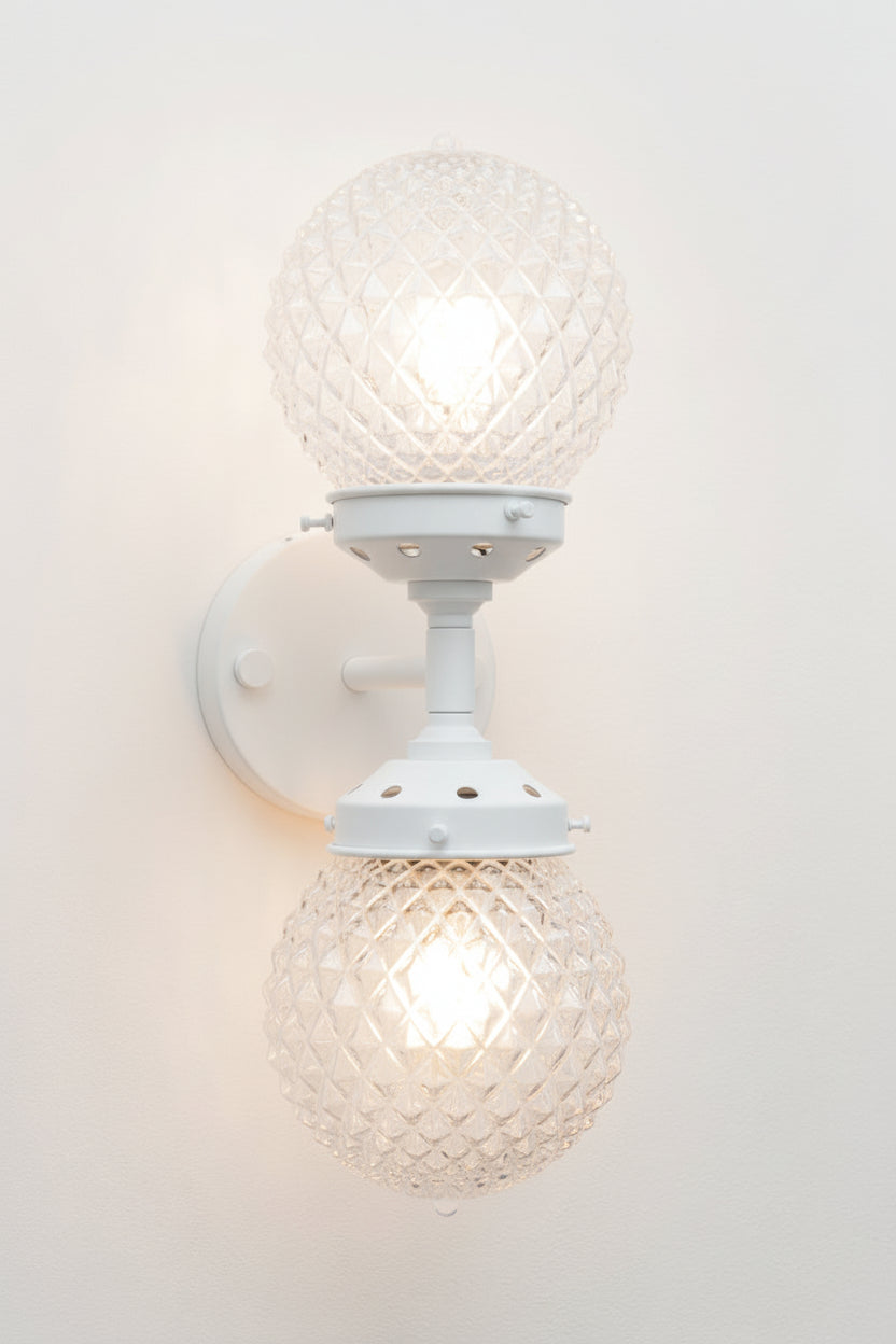 Dual lampholders provide balanced illumination, making it suitable as both a feature light and a practical wall sconce.