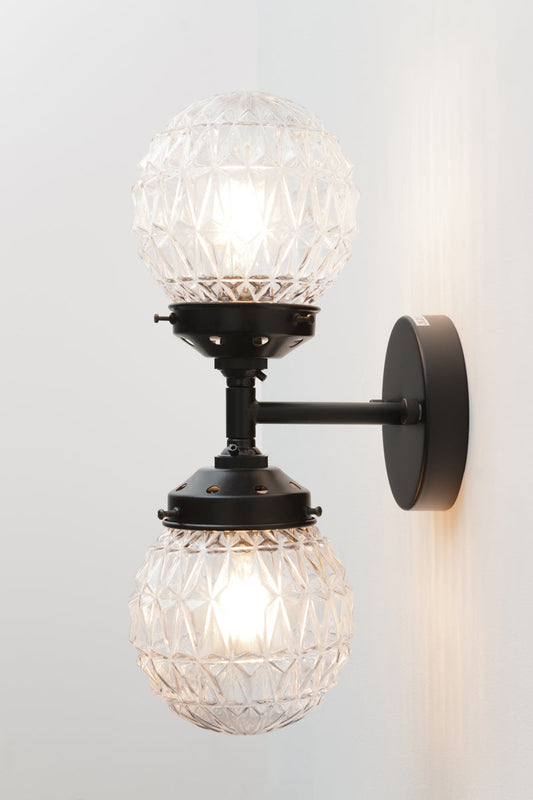 a stylish double wall light with a mid-century modern inspired design. Providing two light sources on one fixture.