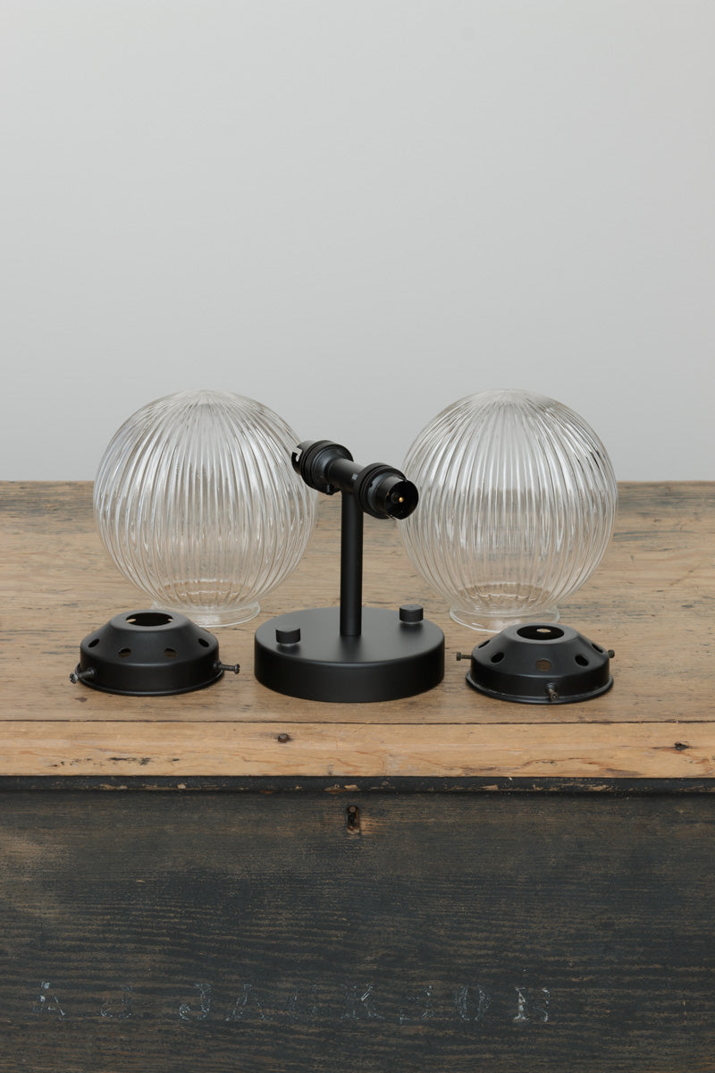 two clear glass shades with reeded detailing and black sonce and gallery